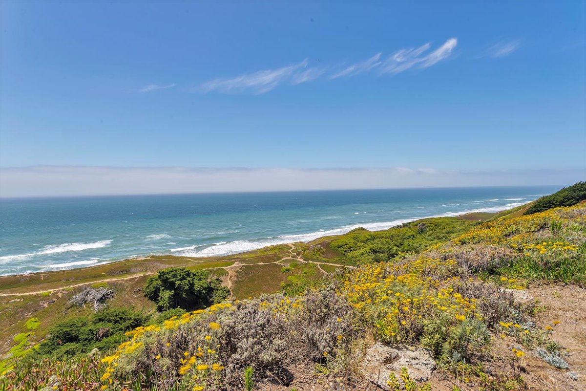 The wide green bluff above the open Pacific beside Ocean View Stables in Daly City, California