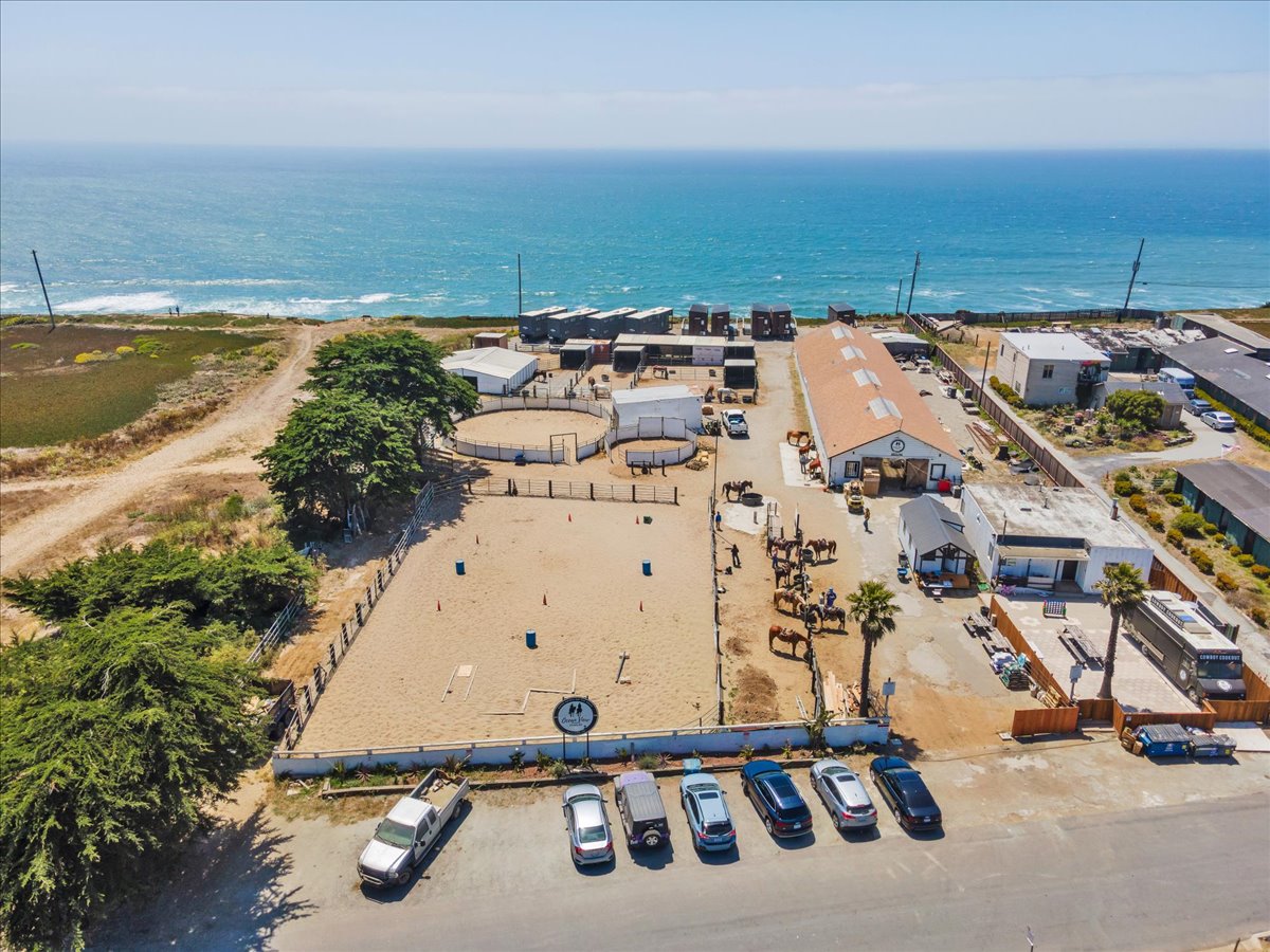 Aerial view of Ocean View Stables showing the arena, barns and paddocks on the bluff above the Pacific in Daly City